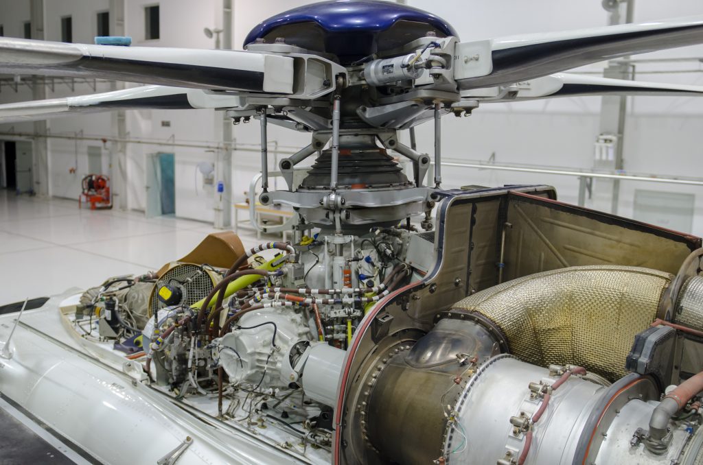 Helicopter gas-turbine engine with the cowling opened for maintenance in hangar